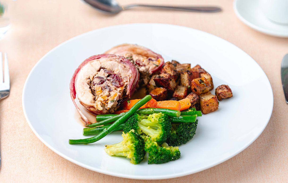 Roasted turkey leg rolled in smoked bacon filled with Philly, apricot and cranberry - Bidfood