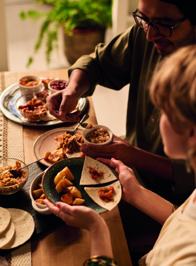 Image of people sharing food from 2 plates