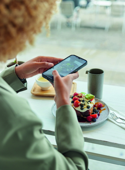 Person taking photo of food plate